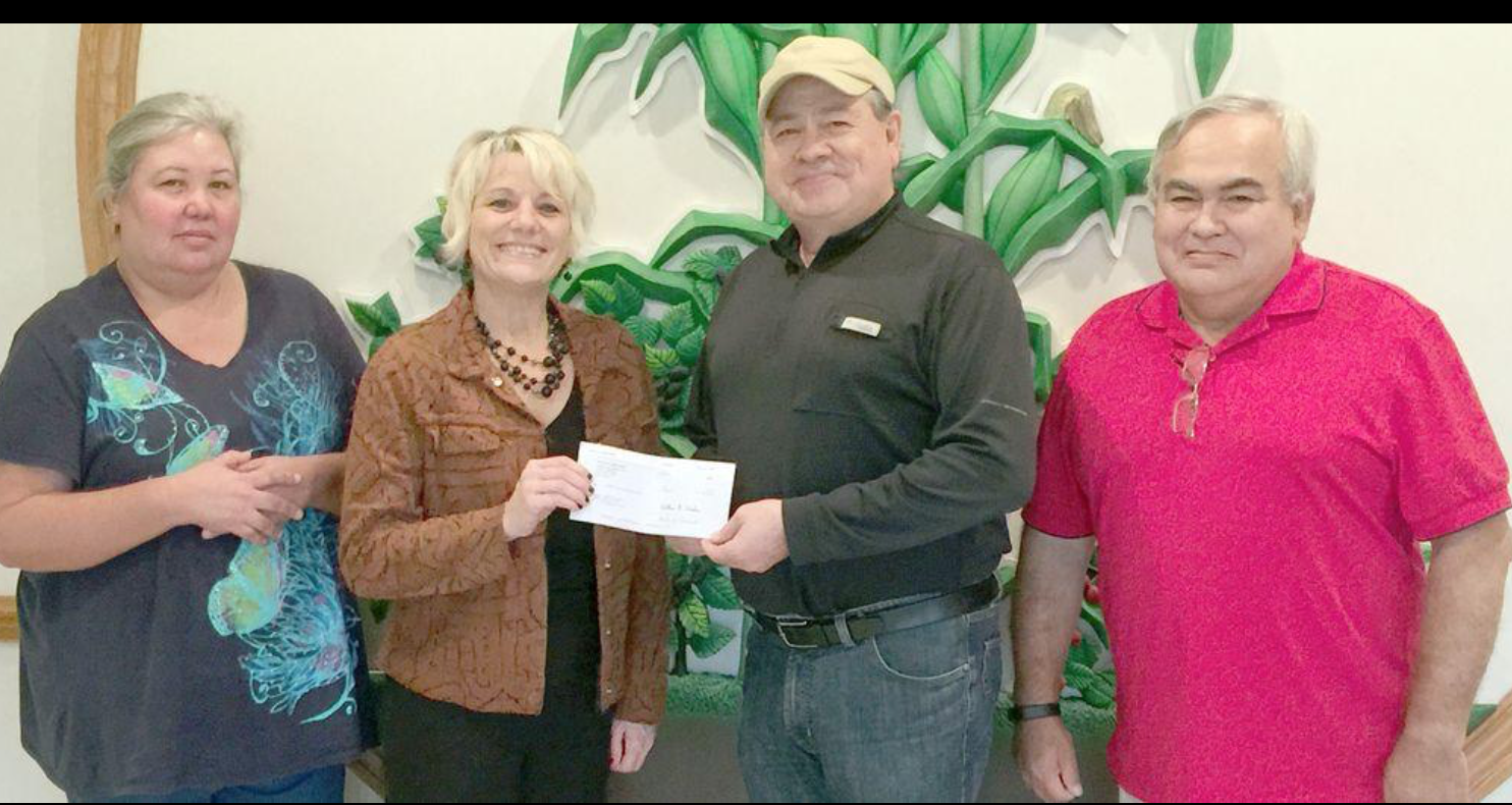image of chief handing check to turkey ford officials