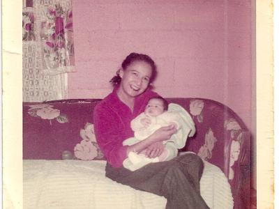 Chief William Fisher at 3-4  months old, being held by Romere Martin in year 1956.
