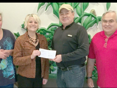 image of chief handing check to turkey ford officials