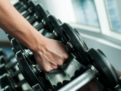 image of hand picking up dumbbell 