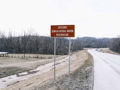 image of road sign that says "entering seneca-cayuga nation reservation"