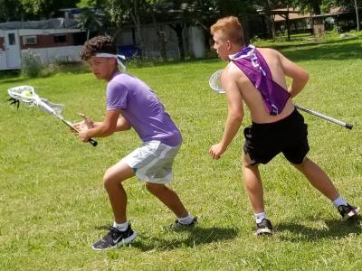 image of young tribal members playing lacrosse