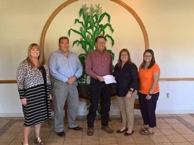 Chief Diebold handing a check to Turkey Ford School Officials
